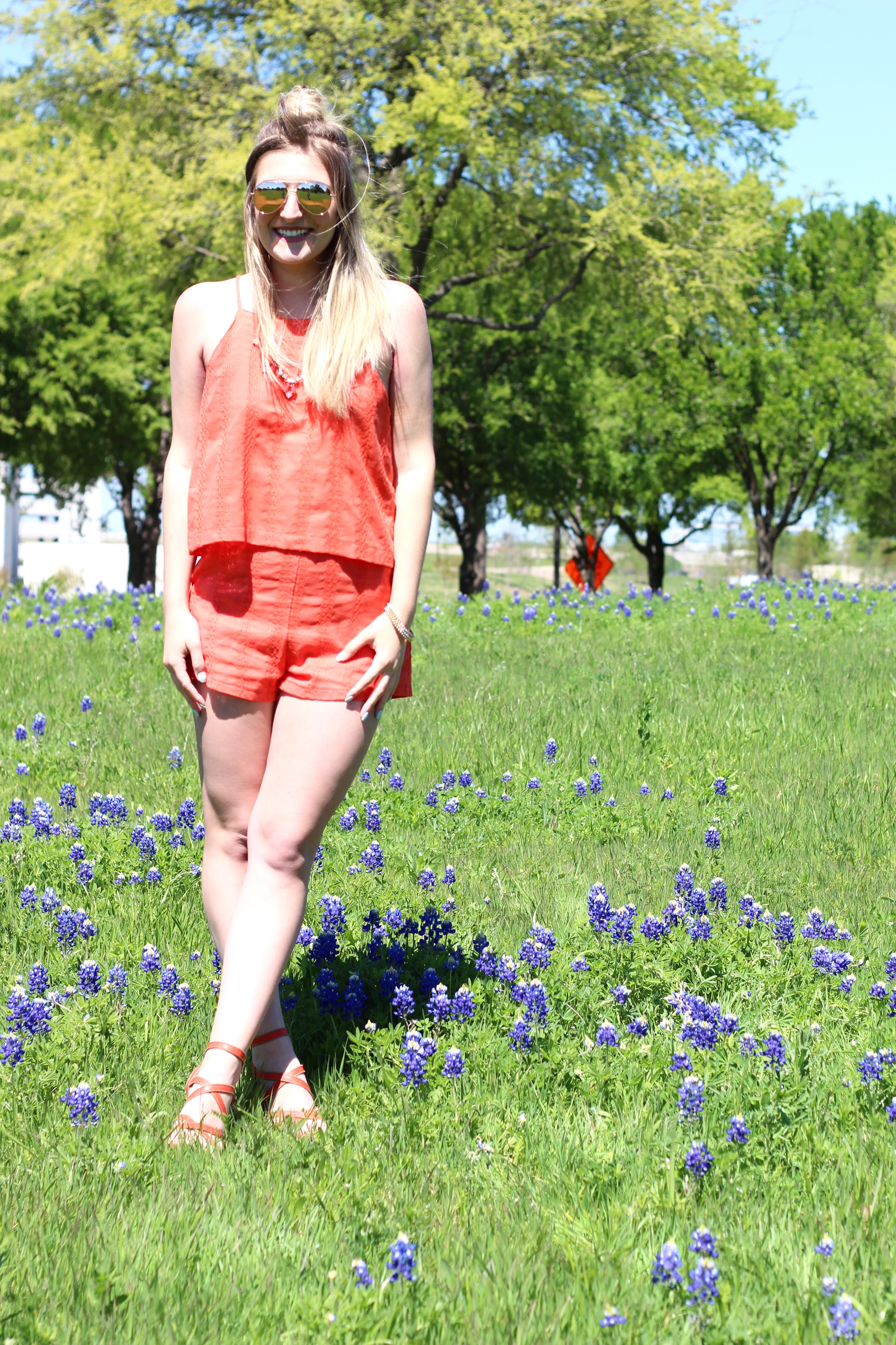 blue bonnets in texas in an orange outfit