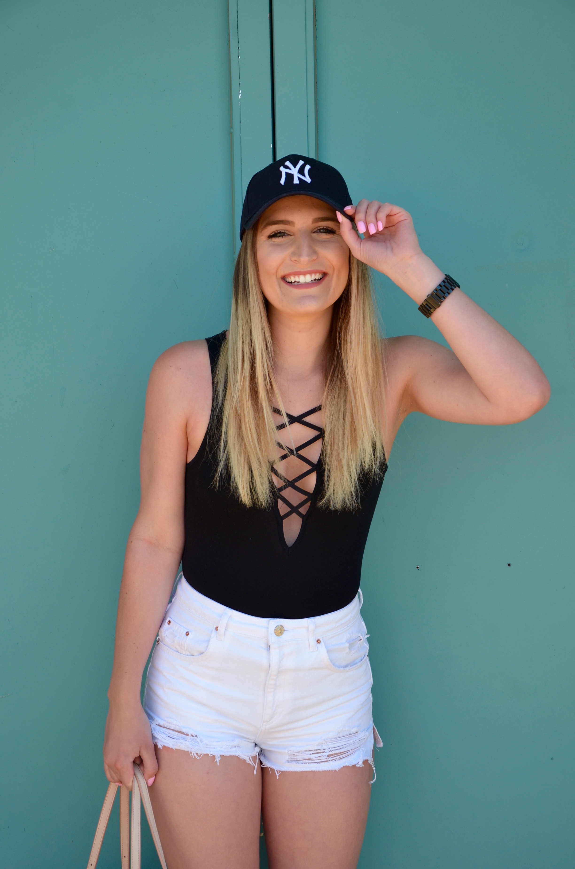 lace up top and white shorts - Travel Outfit Of The Day by popular Texas style blogger Audrey Madison Stowe