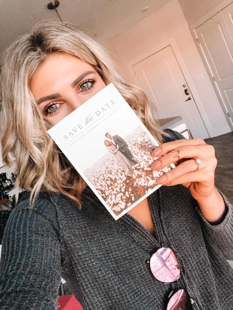 Save The Date Ideas featured by top US lifestyle blogger Audrey Madison Stowe; Image of blonde woman holding a save the date card.
