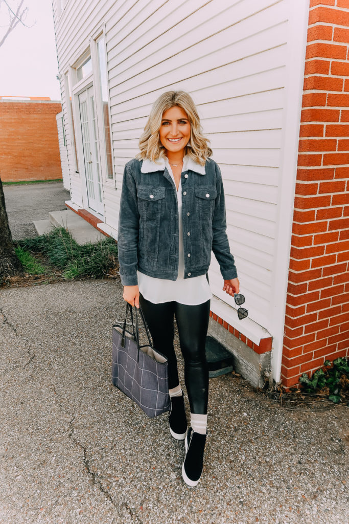 Ways To Wear a White Blouse featured by top US fashion blogger Audrey Madison Stowe; Image of woman wearing white blouse, denim jacket, faux leather leggings and Steve Madden wedges.