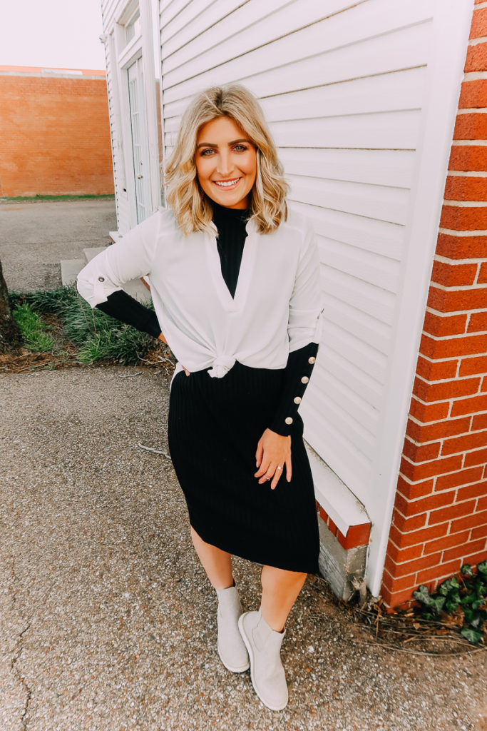 Ways To Wear a White Blouse featured by top US fashion blogger Audrey Madison Stowe; Image of woman wearing white blouse and black midi sweater dress.
