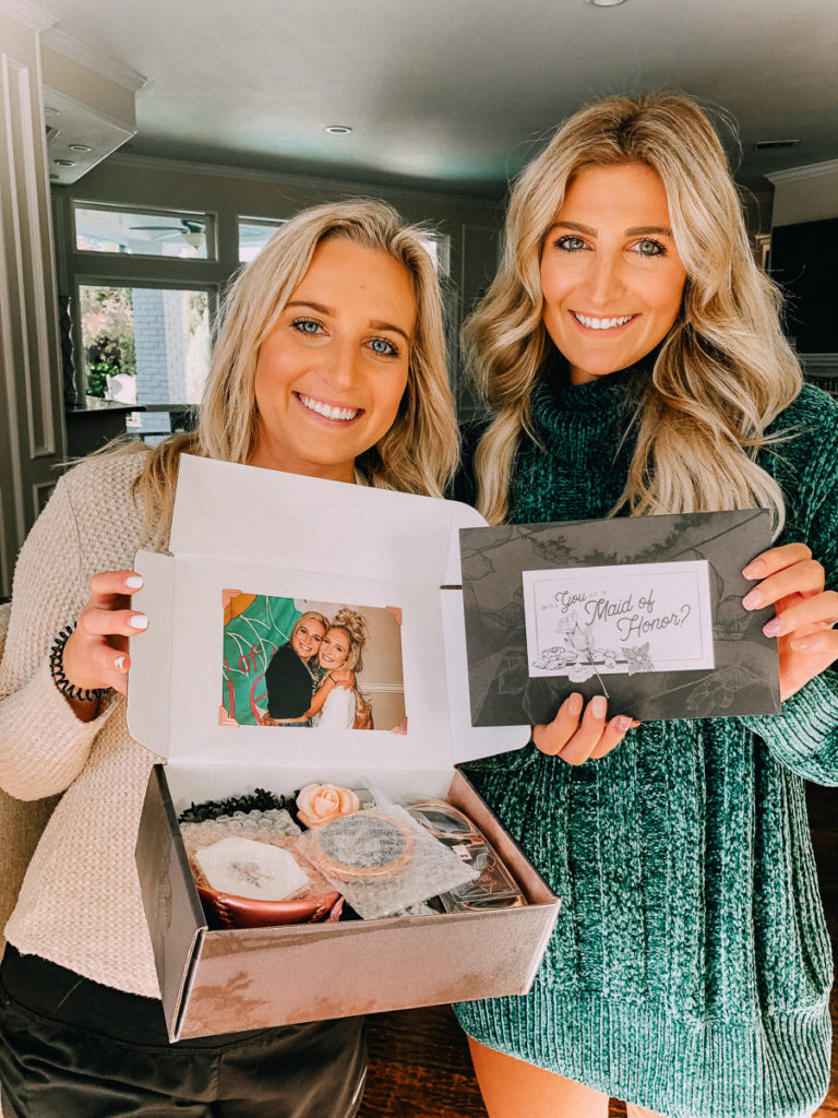 How to Ask your Bridesmaids featured by top US lifestyle blogger Audrey Madison Stowe; Two women standing together smiling.